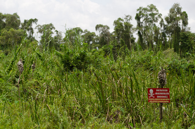 The sign on the right warns of the dangers of landmines beyond this point. Photo © 2013 Aaron Saunders