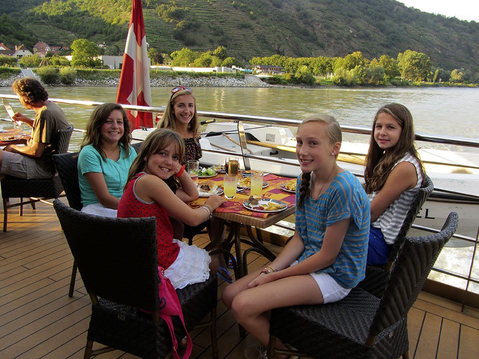 Some lines are more family-friendly than others. Here, guests enjoy lunch out on deck on one of Tauck's Tauck Bridges family river cruises. Photo courtesy of Tauck.