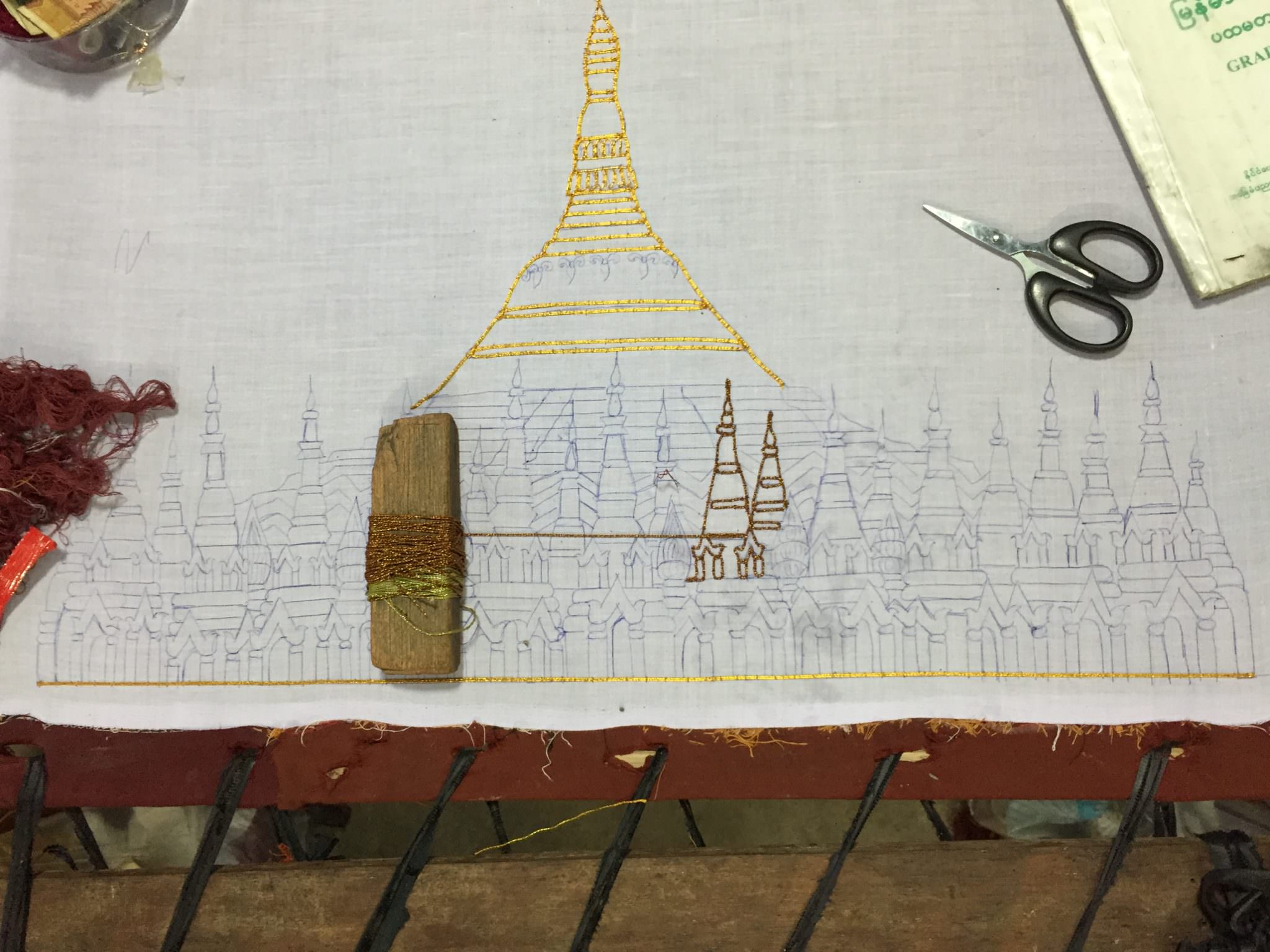Detail of a kalaga in progress. Surprising to no one, this canvas will transform into a gold stupa. © 2015 Gail Jessen