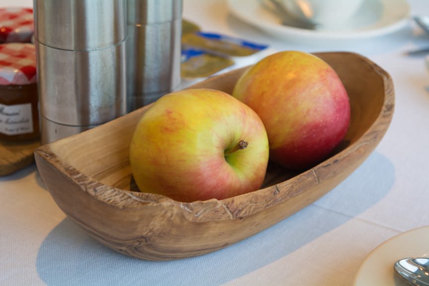Fresh apples are placed in hand-carved wooden baskets on tables....Photo © 2016 Aaron Saunders
